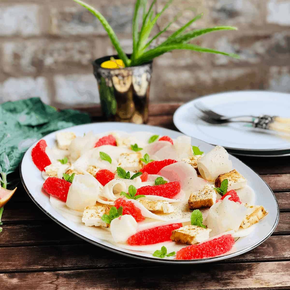 Plate of Kohlrabi, grapefruit and feta salad