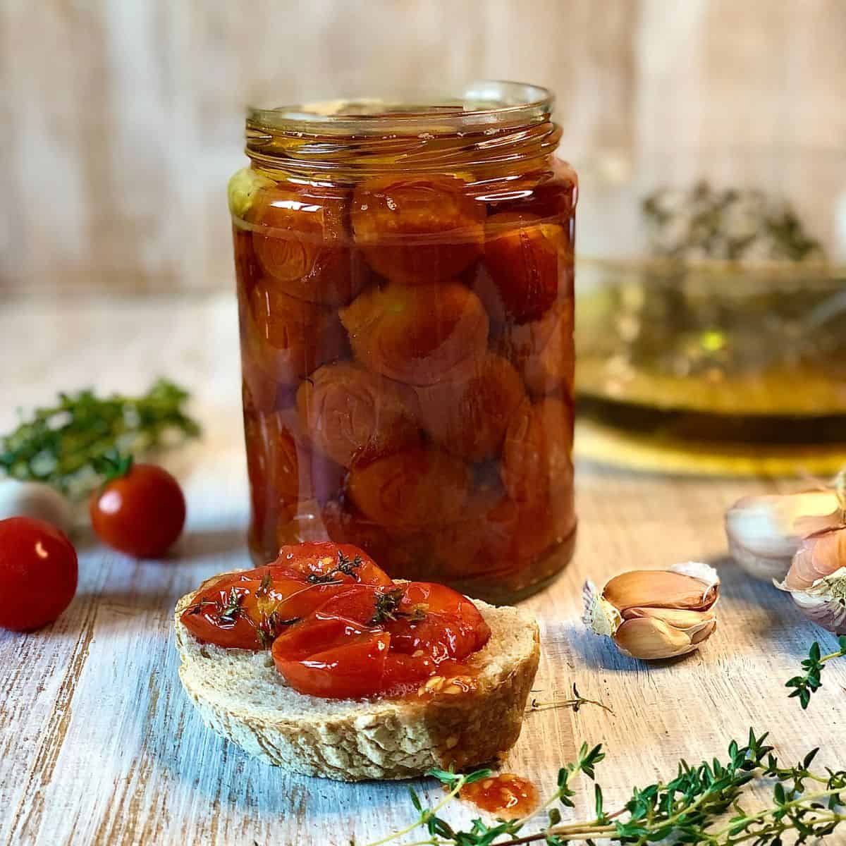 A glass bowl full of confit tomatoes