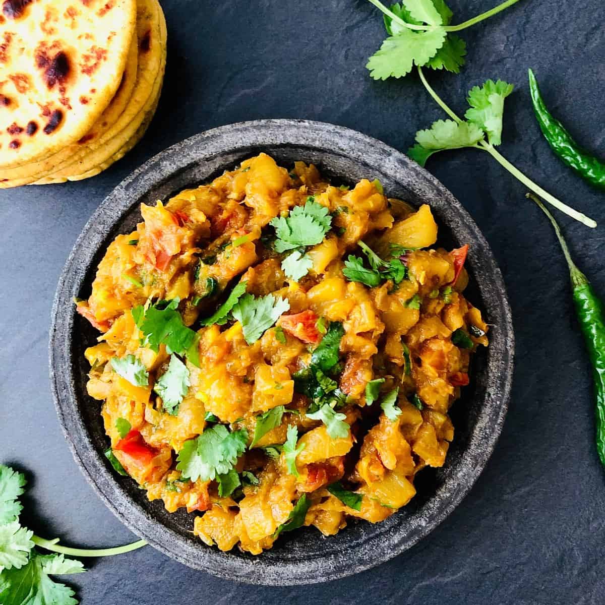 A plate of marrow guhtva garnished with coriander. 
