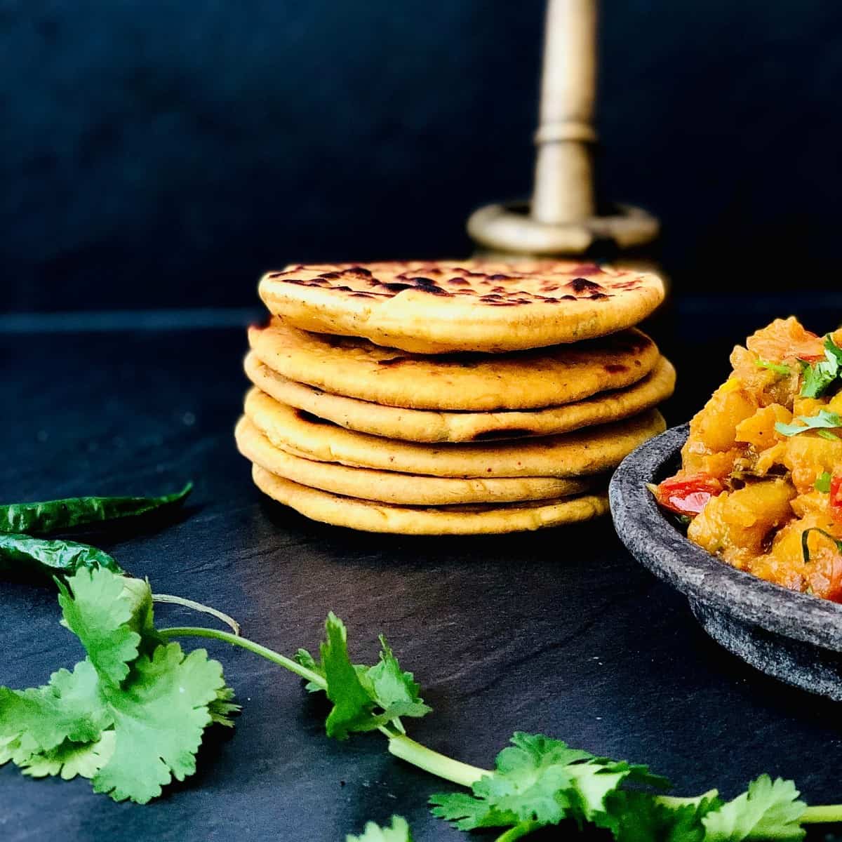 A pile of six tidka flat breads.