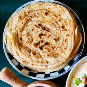 A pile of Laccha Paratha on a plate