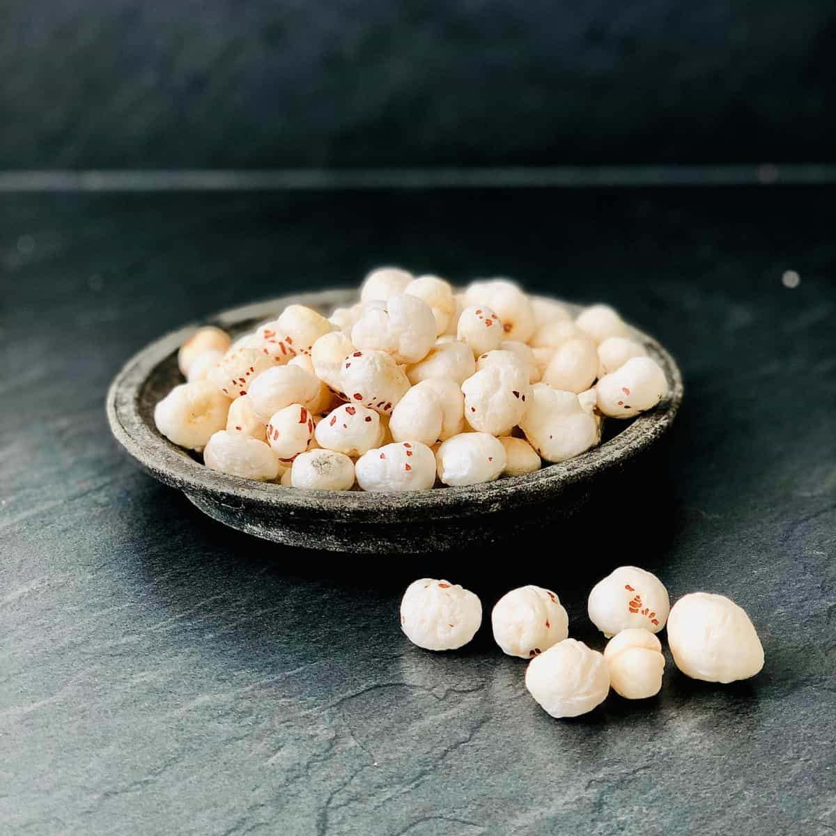 Stoneware dish containing makhana popped lotus seeds 