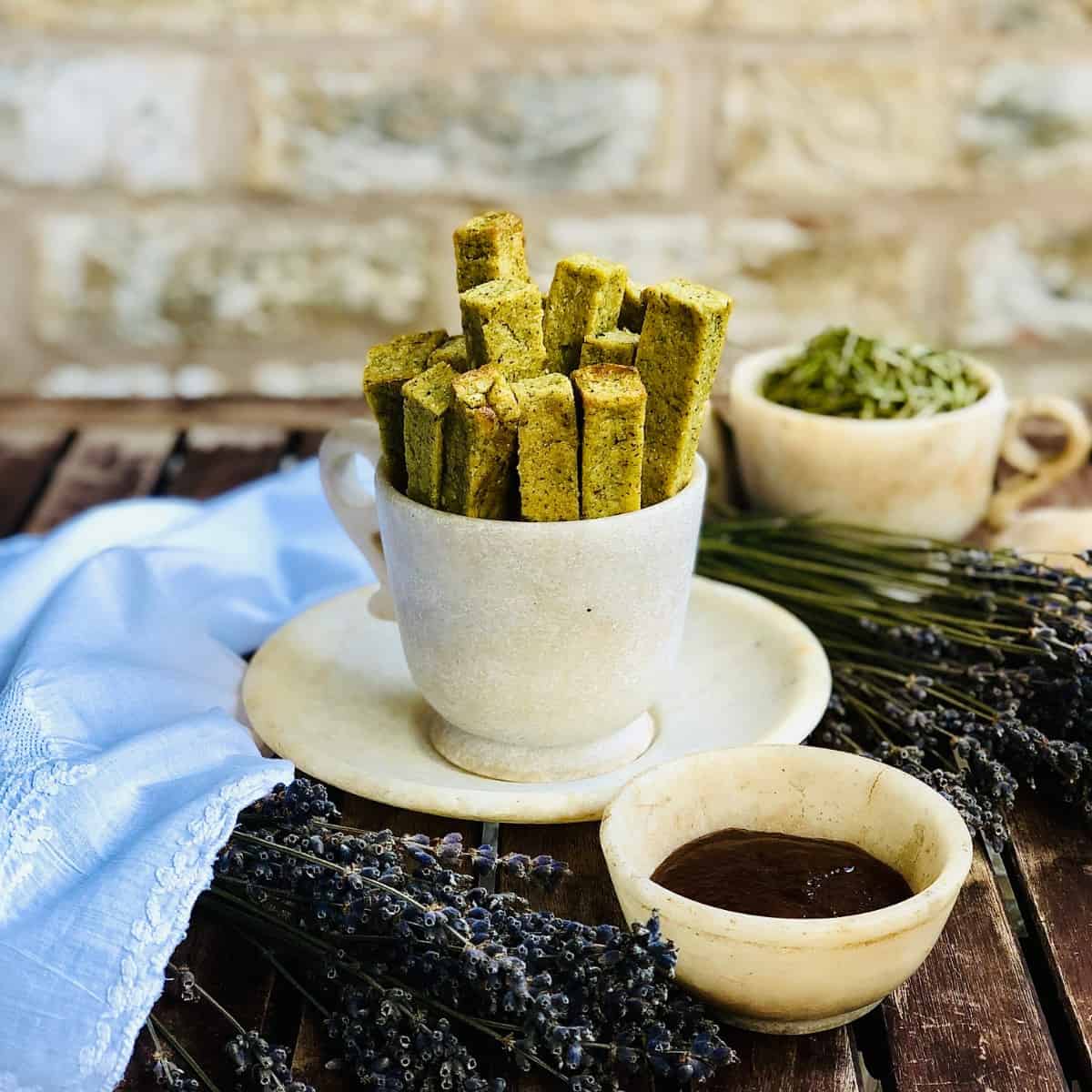 A stoneware cup containing polenta chips.