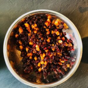 A bowl of chopped fruit for christmas cake. Sultanas, apricots, cranberries and dates