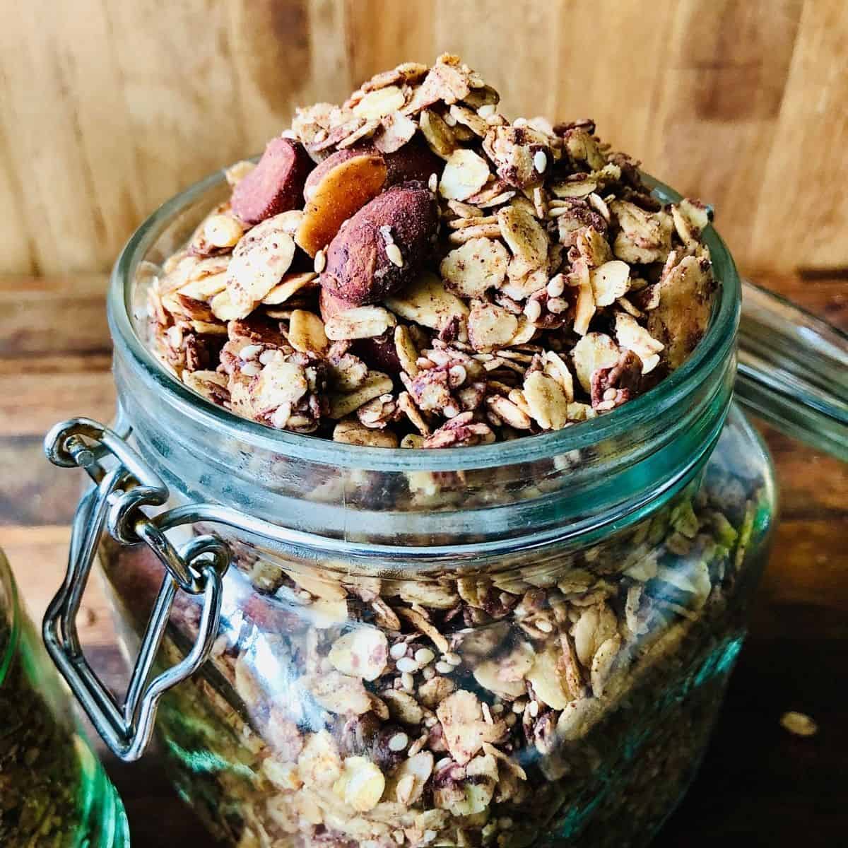 A jar containing chocolate and tahini granola.