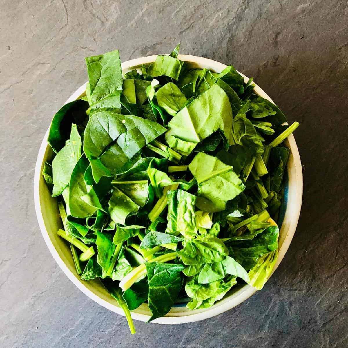 A bowl of roughly chopped spinach