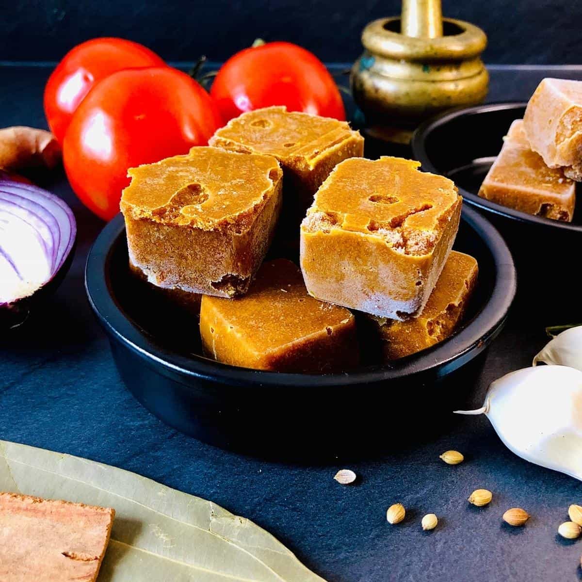 Shallow dish containing frozen Indian gravy cubes.