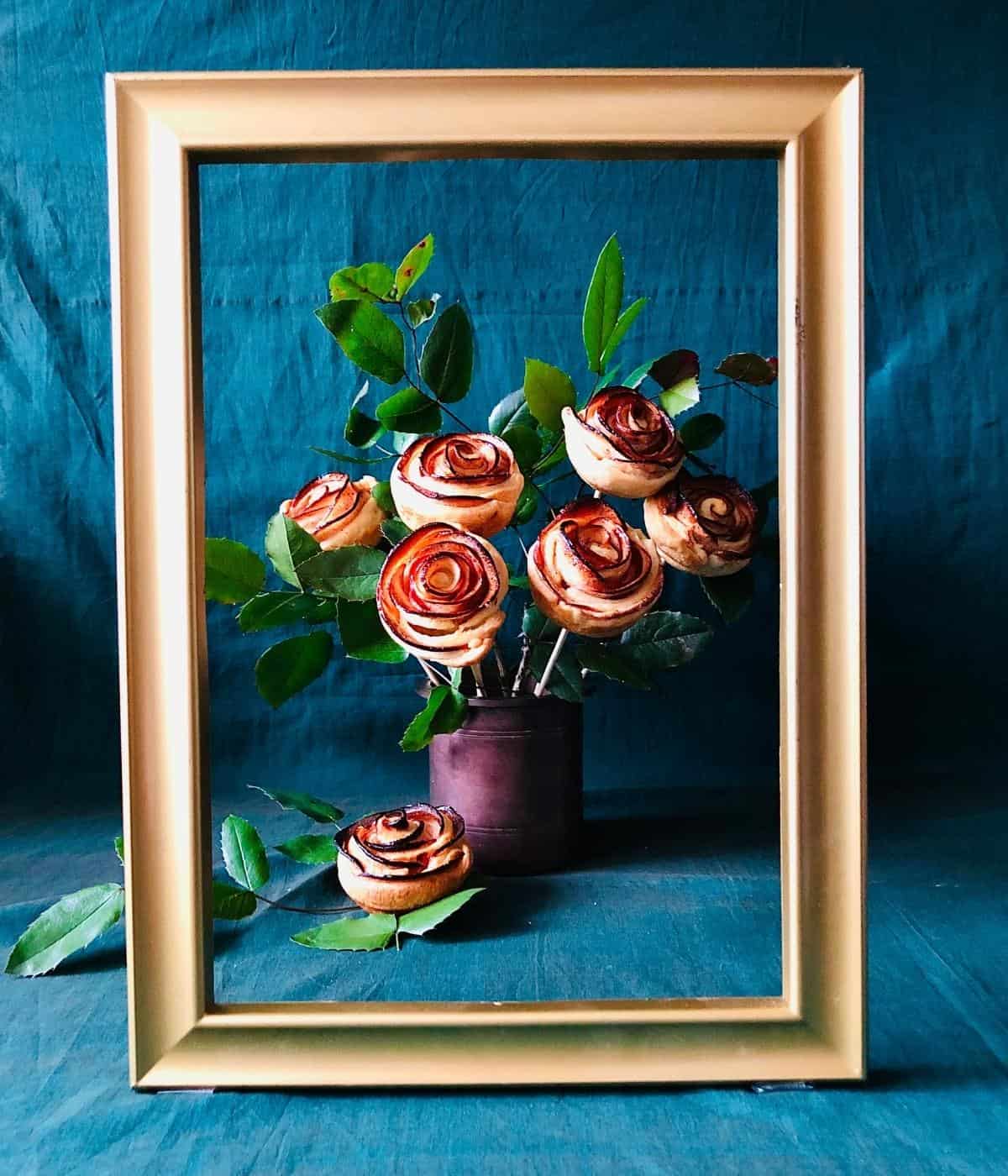 Pastry apple roses in a vase framed by a picture frame