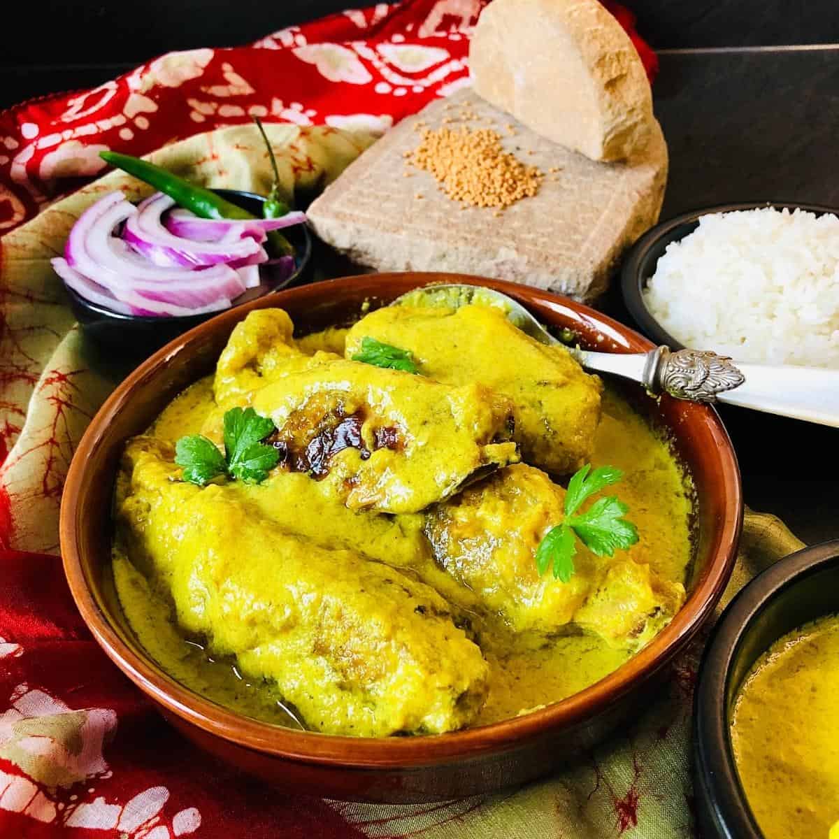 Shallow dish containing vegan fish in a mustard sauce