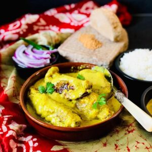 Shallow dish containing vegan fish in a mustard sauce