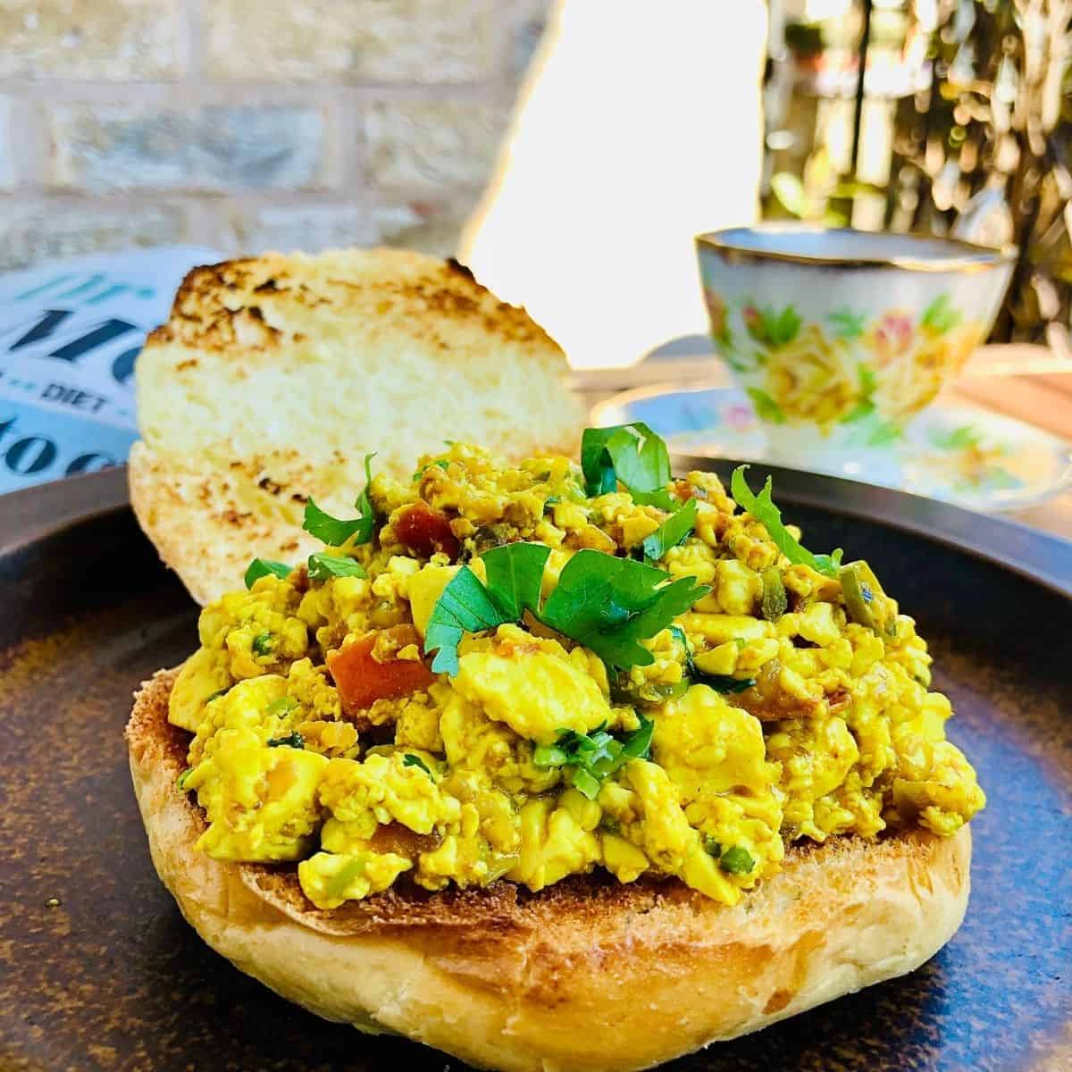 Close up of scrambled tofu on a brioche bun