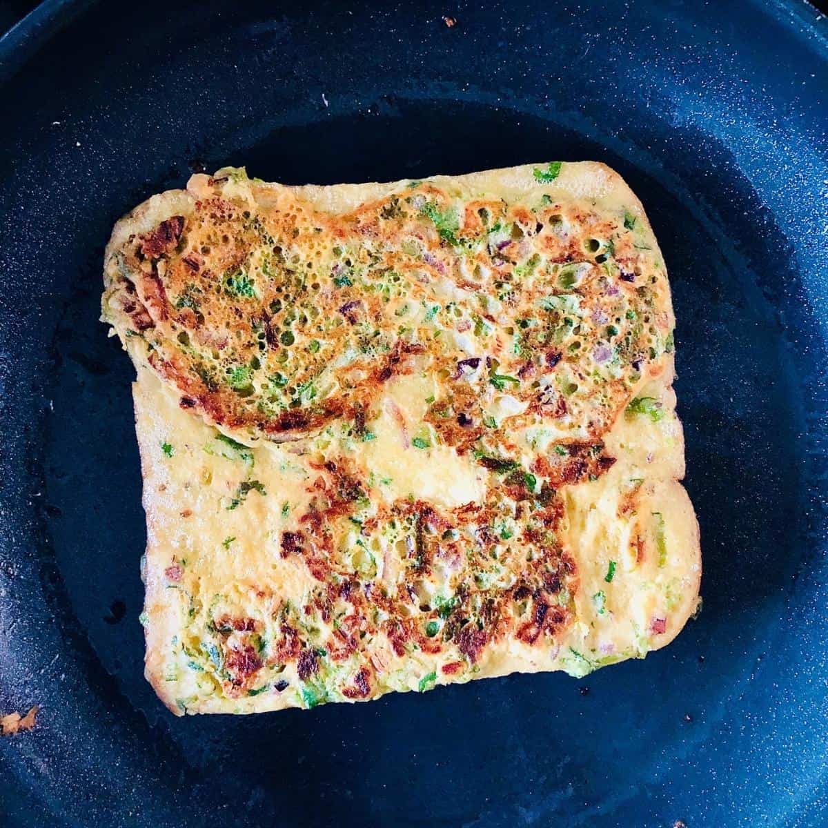 Bread pakora frying in a pan