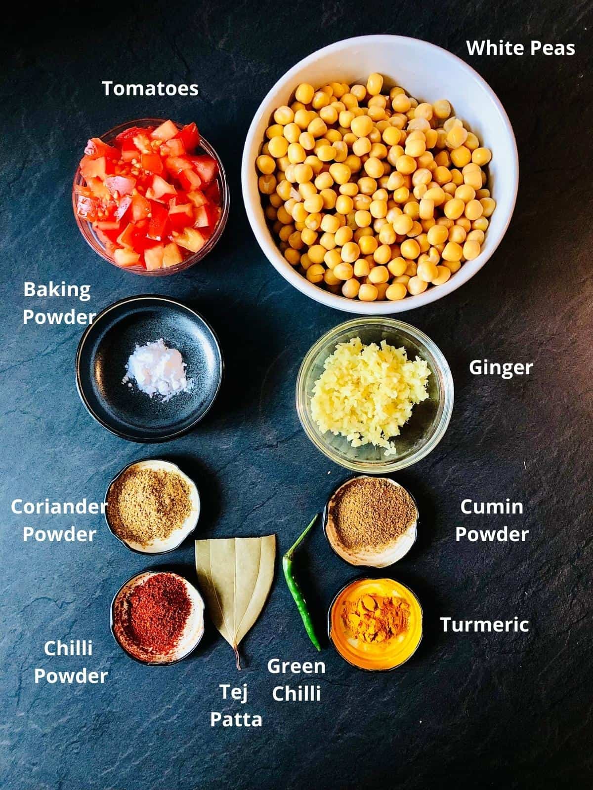 Ghugni ingredients samples prepared and laid out in shallow dished in two columns. Labeled with ingredient name