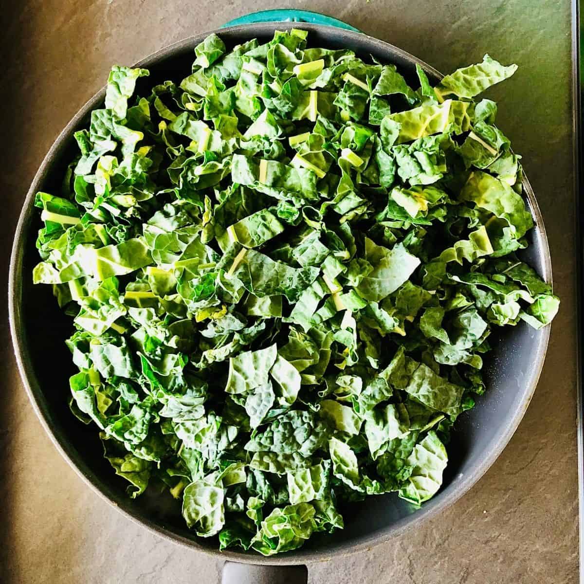 A frying pan full of shredded kale