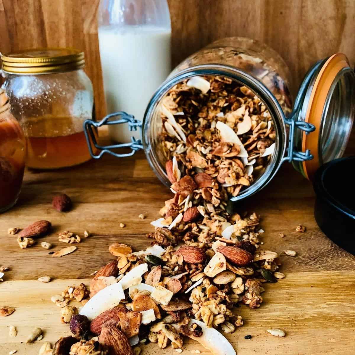 Orange blossom granola spilling from a jar