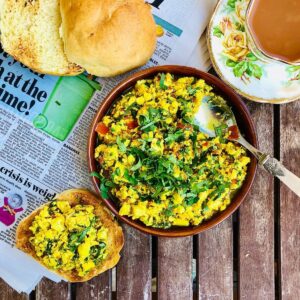 Scrambled tofu in a shallow dish, and a brioche bun topped with scrambled tofu next to it.