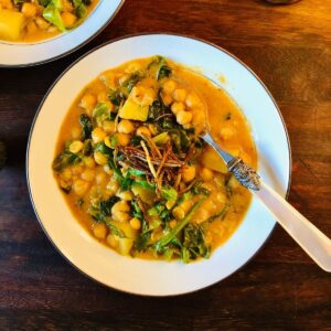 Thai chickpea curry in a serving bowl with a spoon