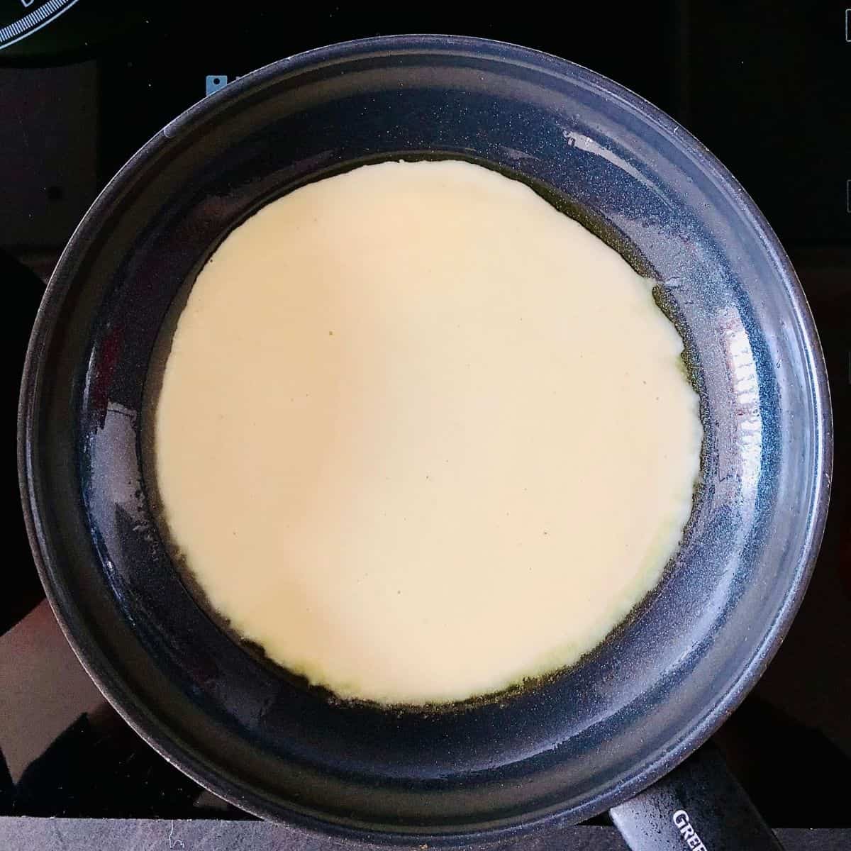 Vegan omelette batter in a frying pan