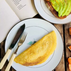 Vegan omelette on a plate with a knife and folk