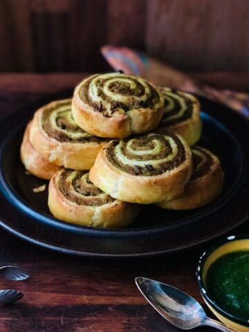 seven pinwheel samosas piled on a plate