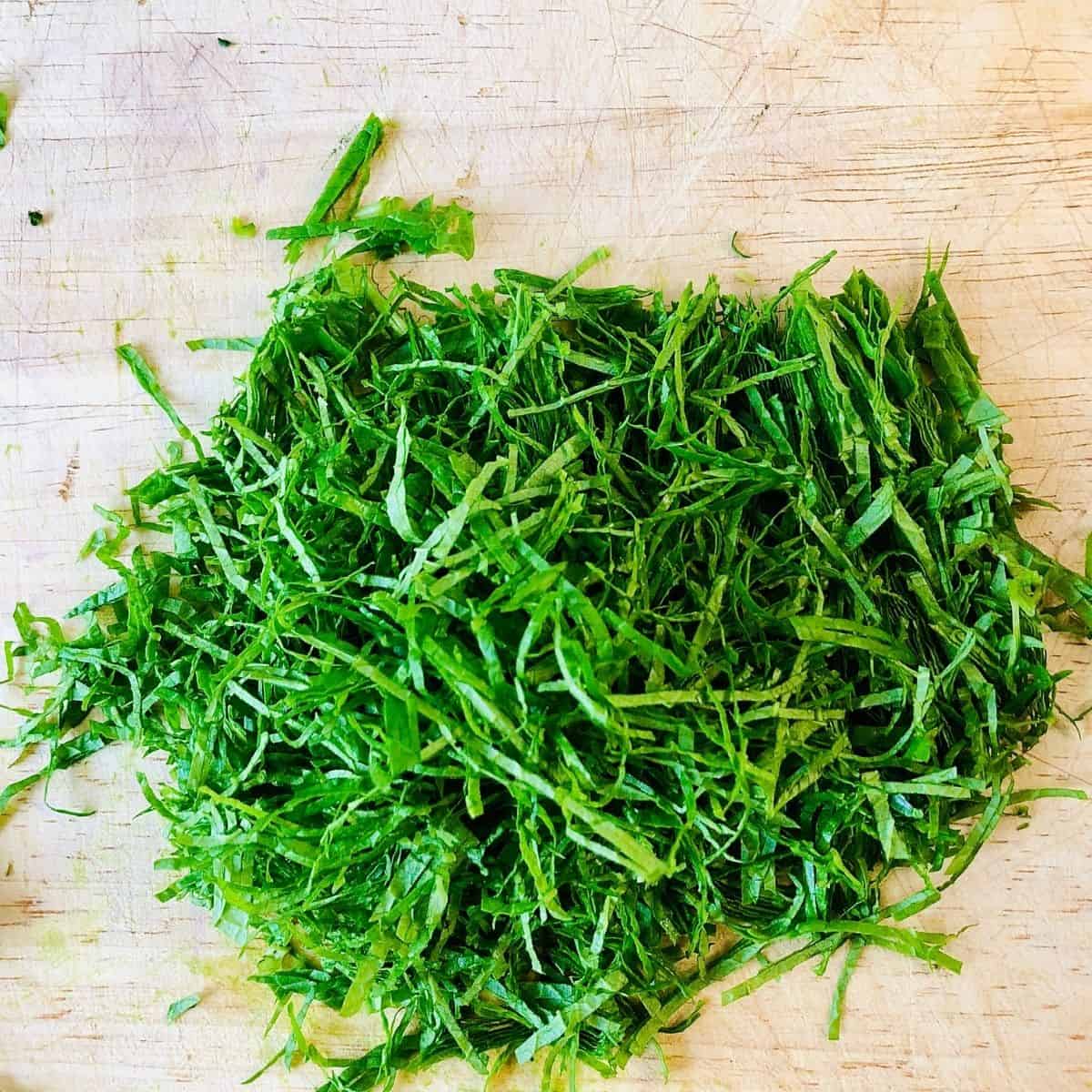 Close up of finely chopped wild garlic, garlic mustard and ground ivy for salsa verde