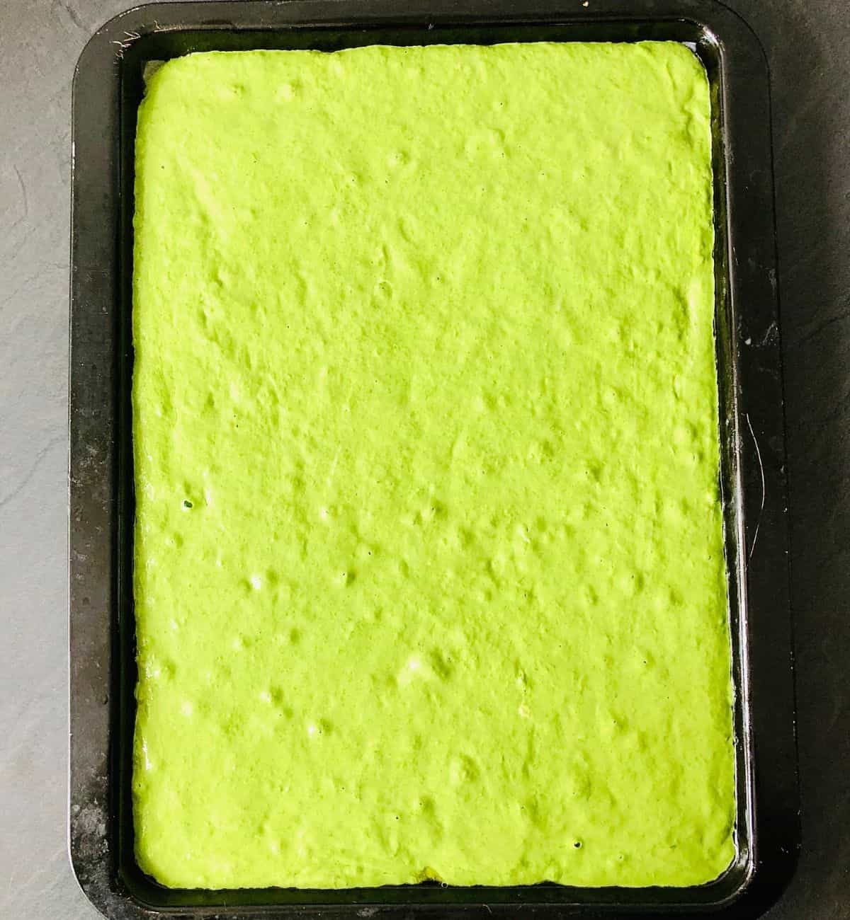 Wild garlic focaccia dough in a baking tray ready for second proving