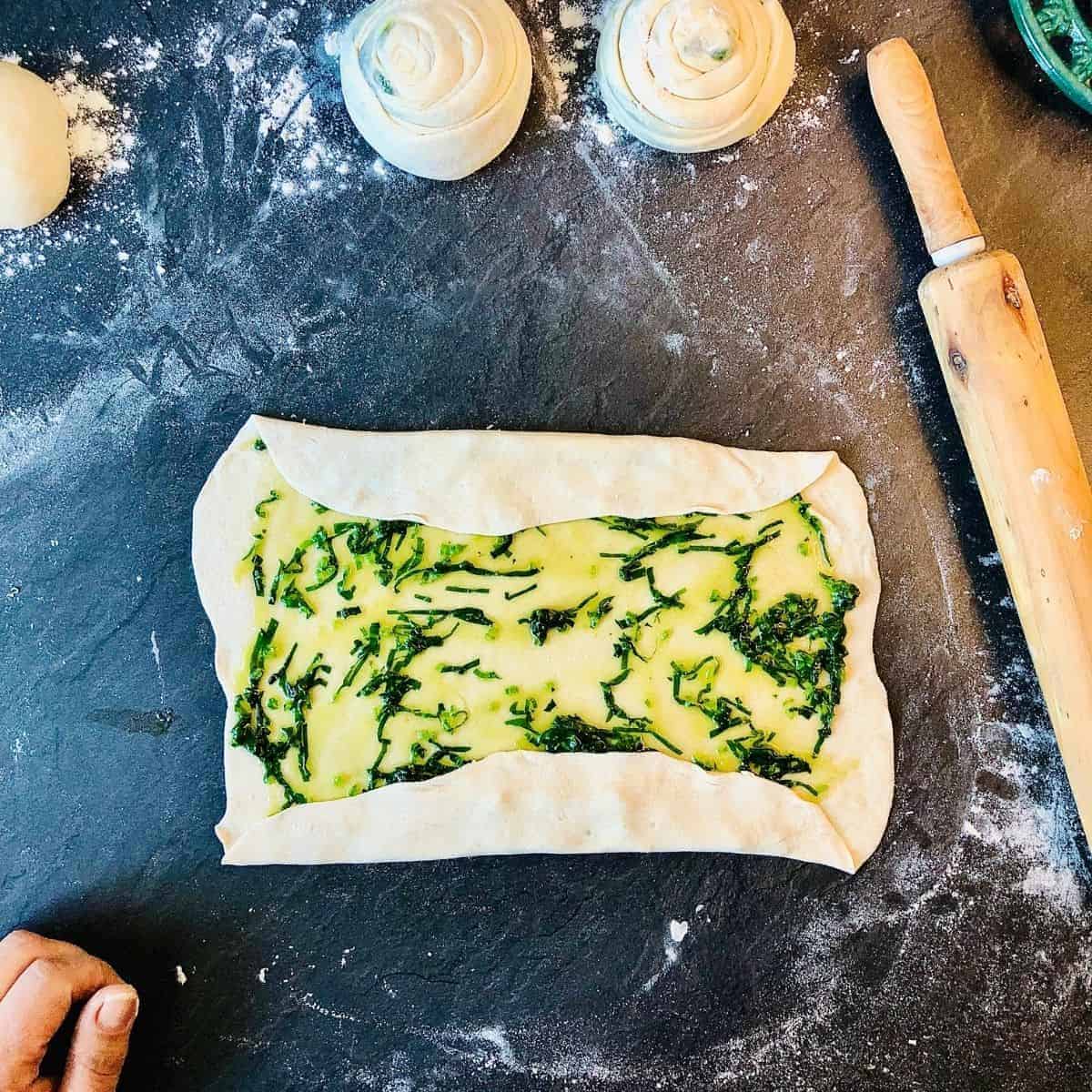 Folding wild garlic laccha paratha dough