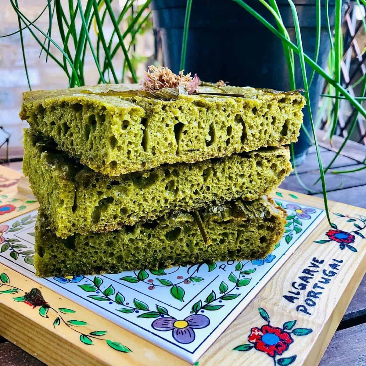 A pile of three slices of no knead wild garlic focaccia