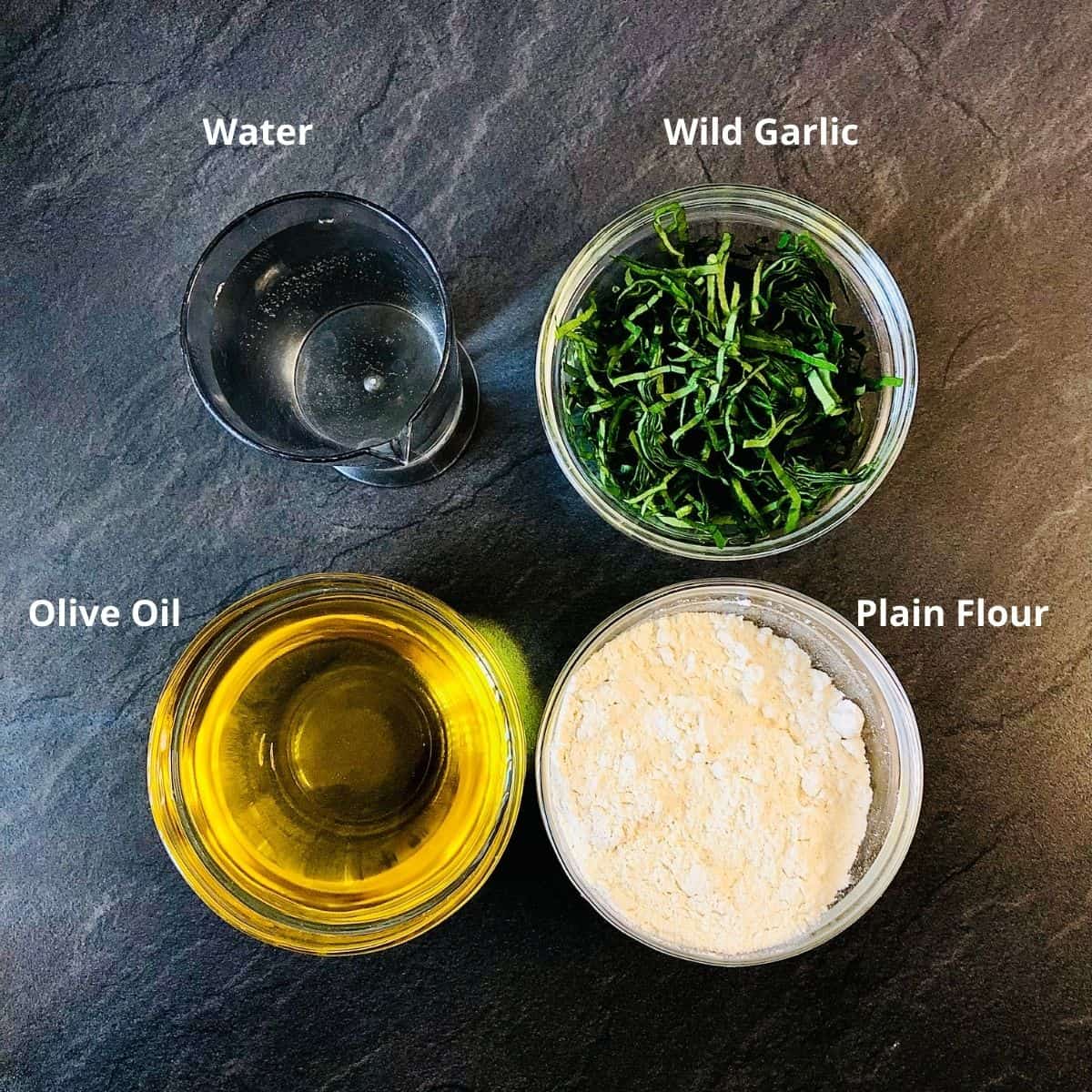 Ingredients for wild garlic laccha paratha in small glass dishes. Annotated.