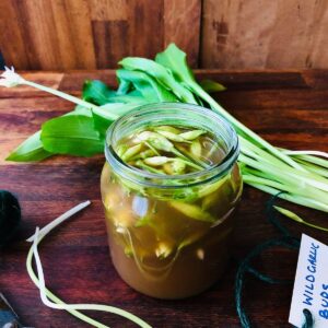 A jar containing pickled wild garlic flower buds.