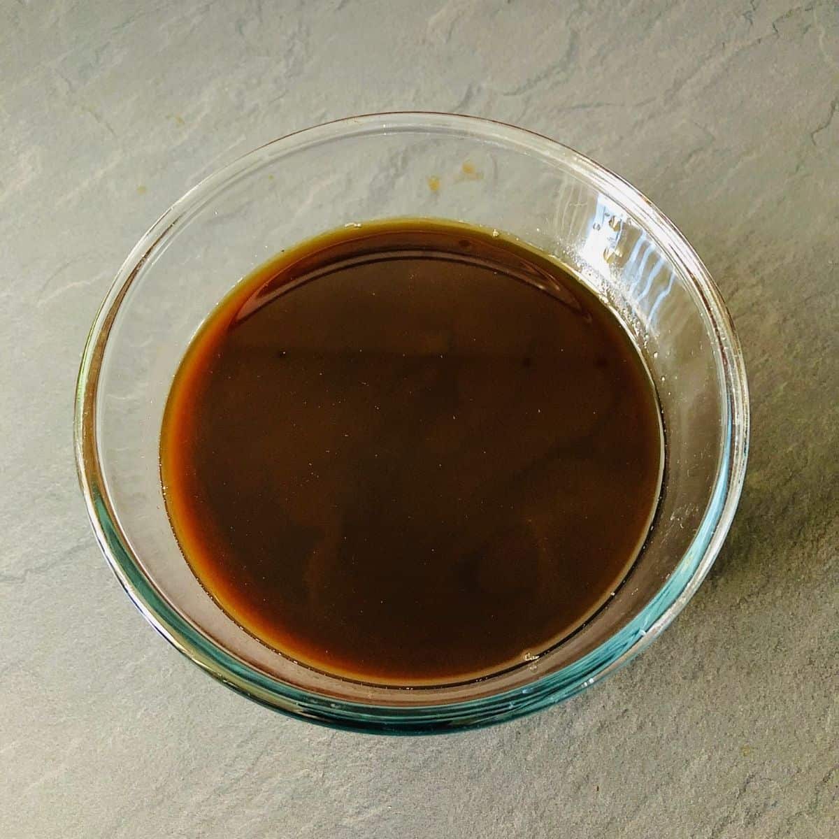 A glass bowl containing strained juice of tamarind