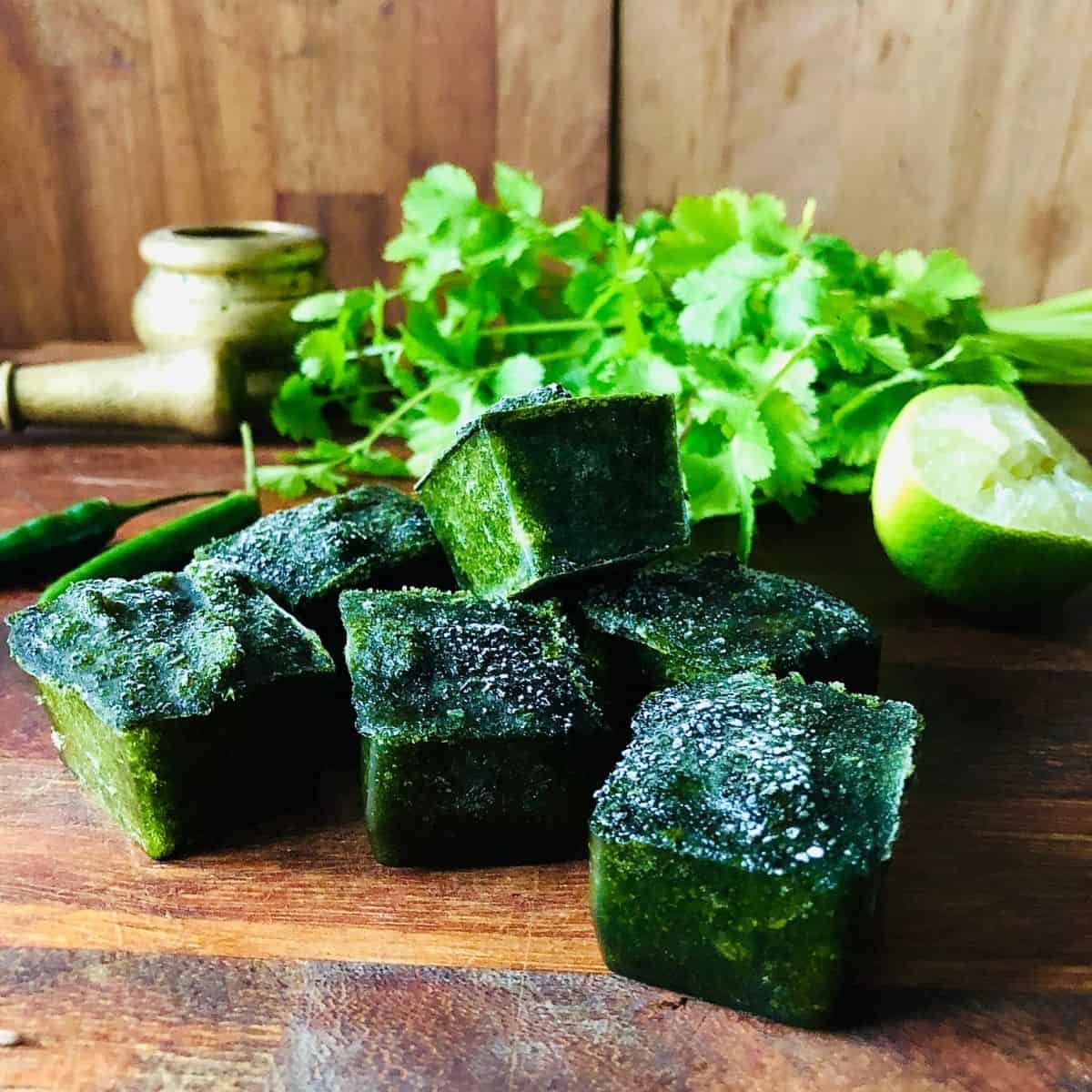 close up of six coriander and chilli chutney ice cubes