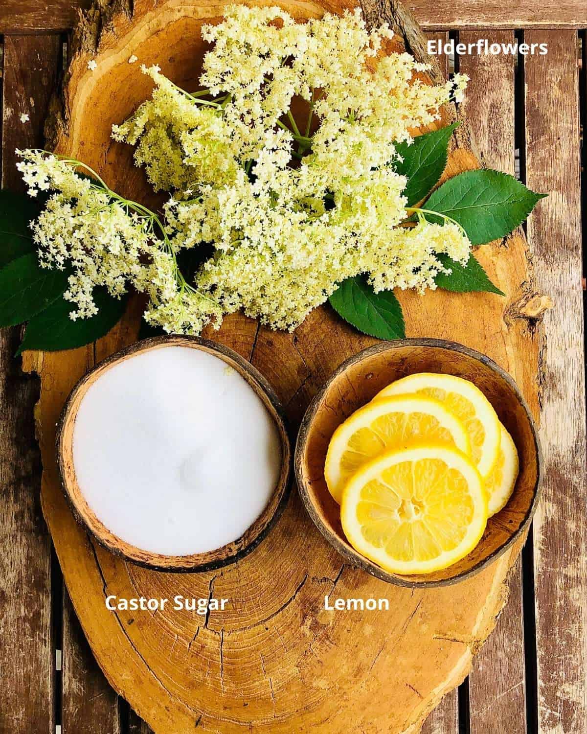 Elderflower cordial ingredients on a wooden platter. Annotated.