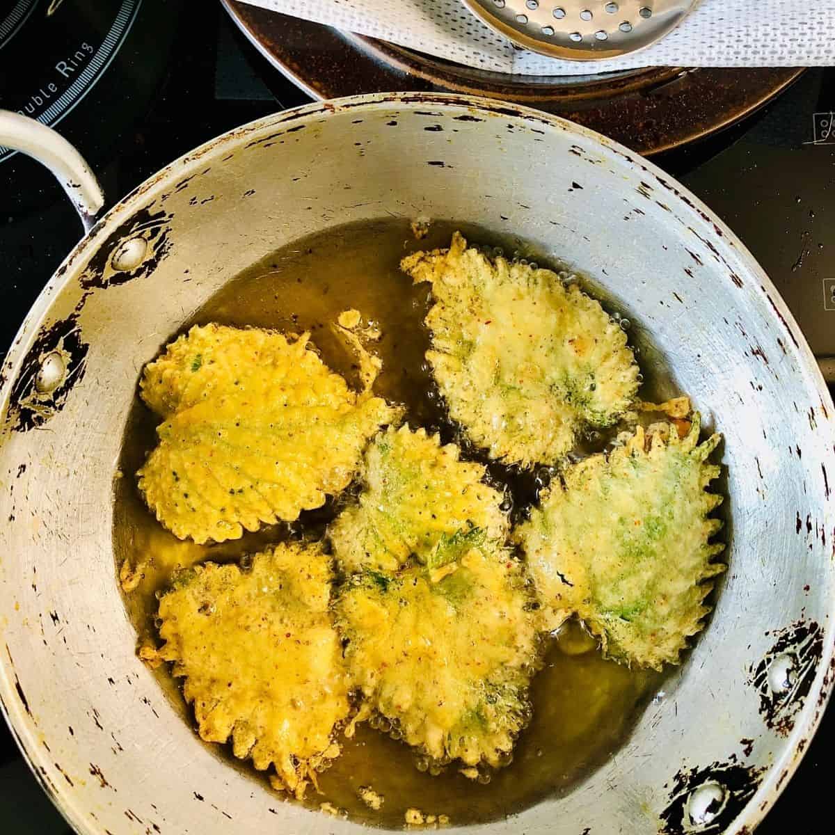 Nettle leaves coated in gram flour better frying in oil in heavy duty frying pan