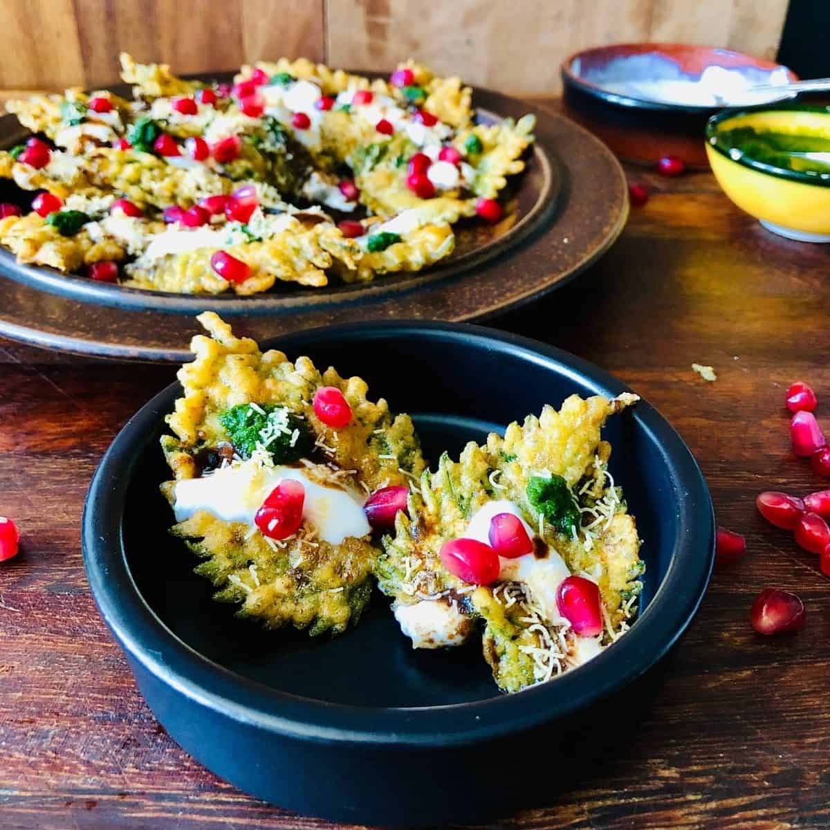 A small dish containing Patte Ki Chaat  Indian snack, made with nettle leaves.