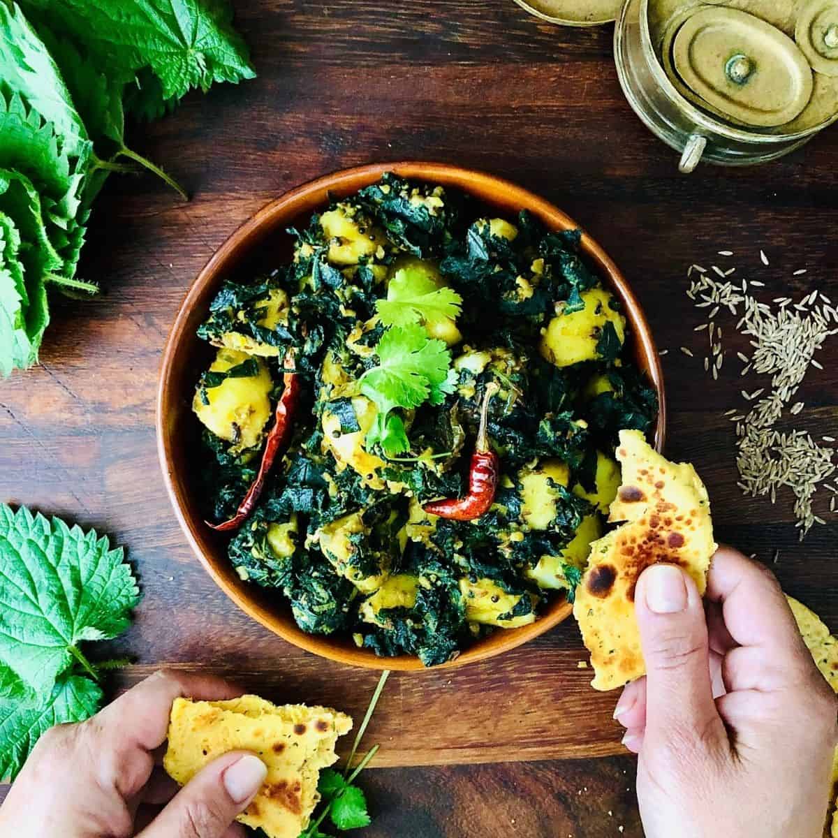 Shallow dish containing saag aloo.