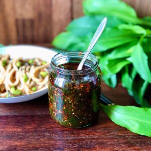 Close up of a jar of wild garlic chilli oil.