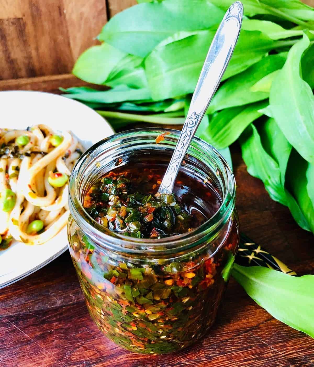 Close up of a glass jar containing wild garlic chilli oil