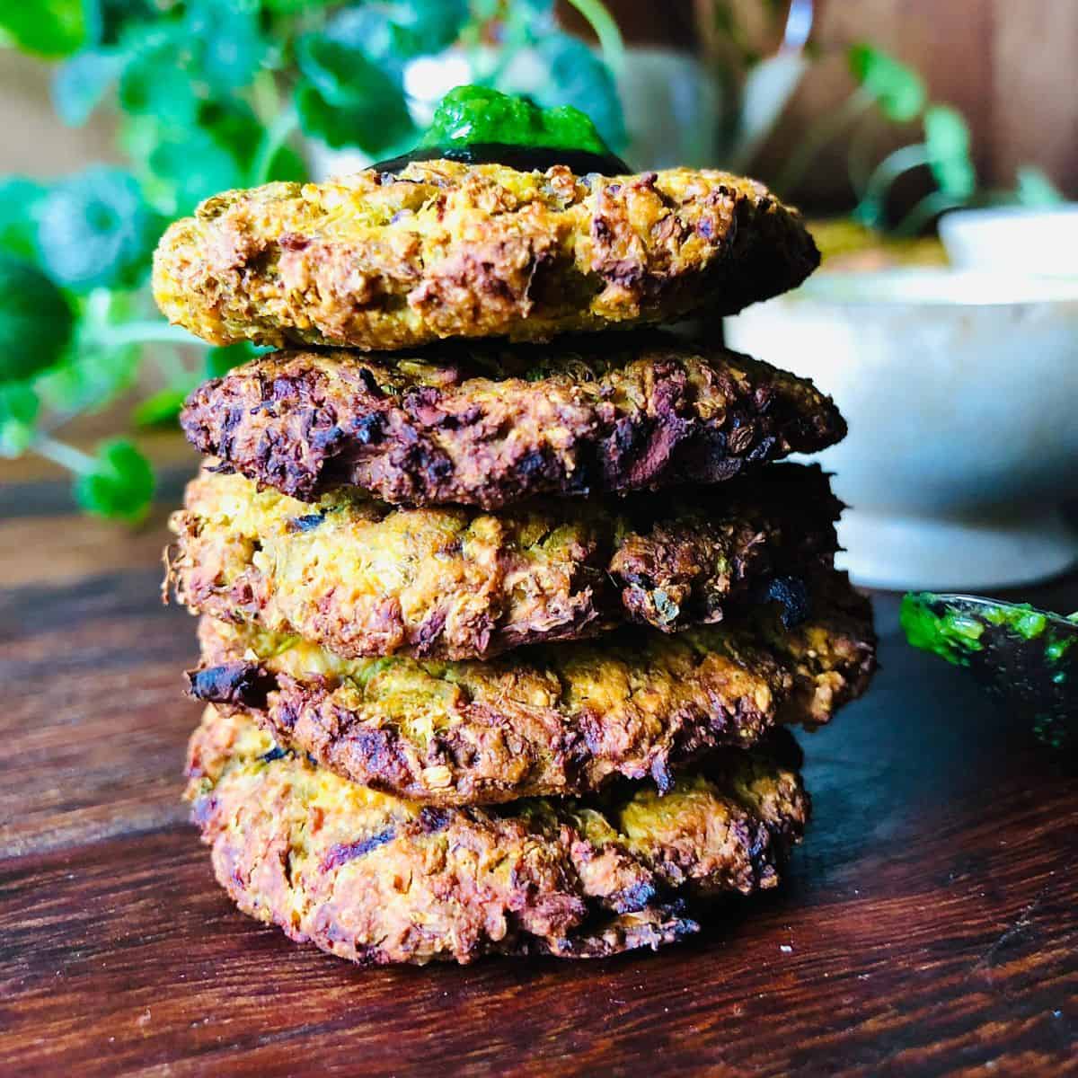 Close-up of a stack of five cooked broccoli fritters.