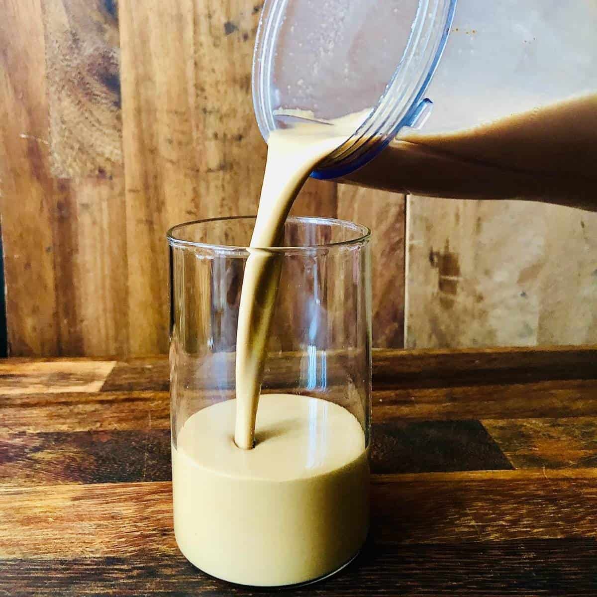 Pouring blended cold coffee into a glass