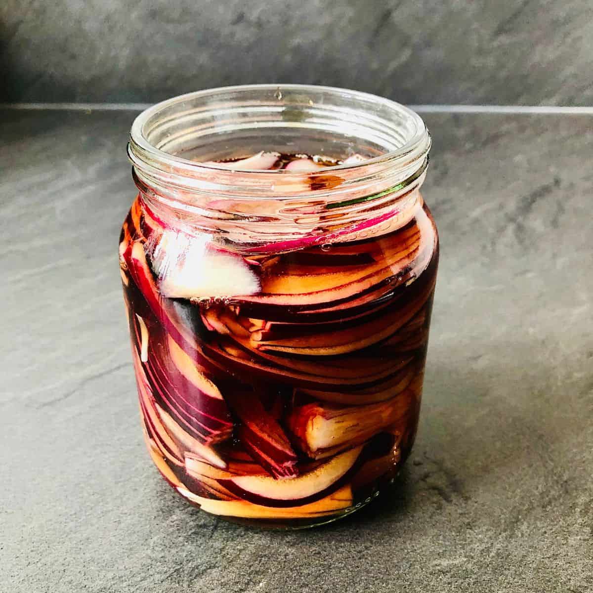 close up of a jar of pickled red onion