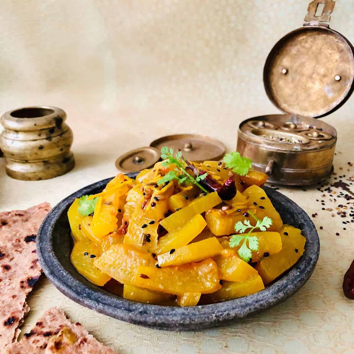 A shallow plate containing Tarbooz Ki Sabzi, watermelon rind dish.