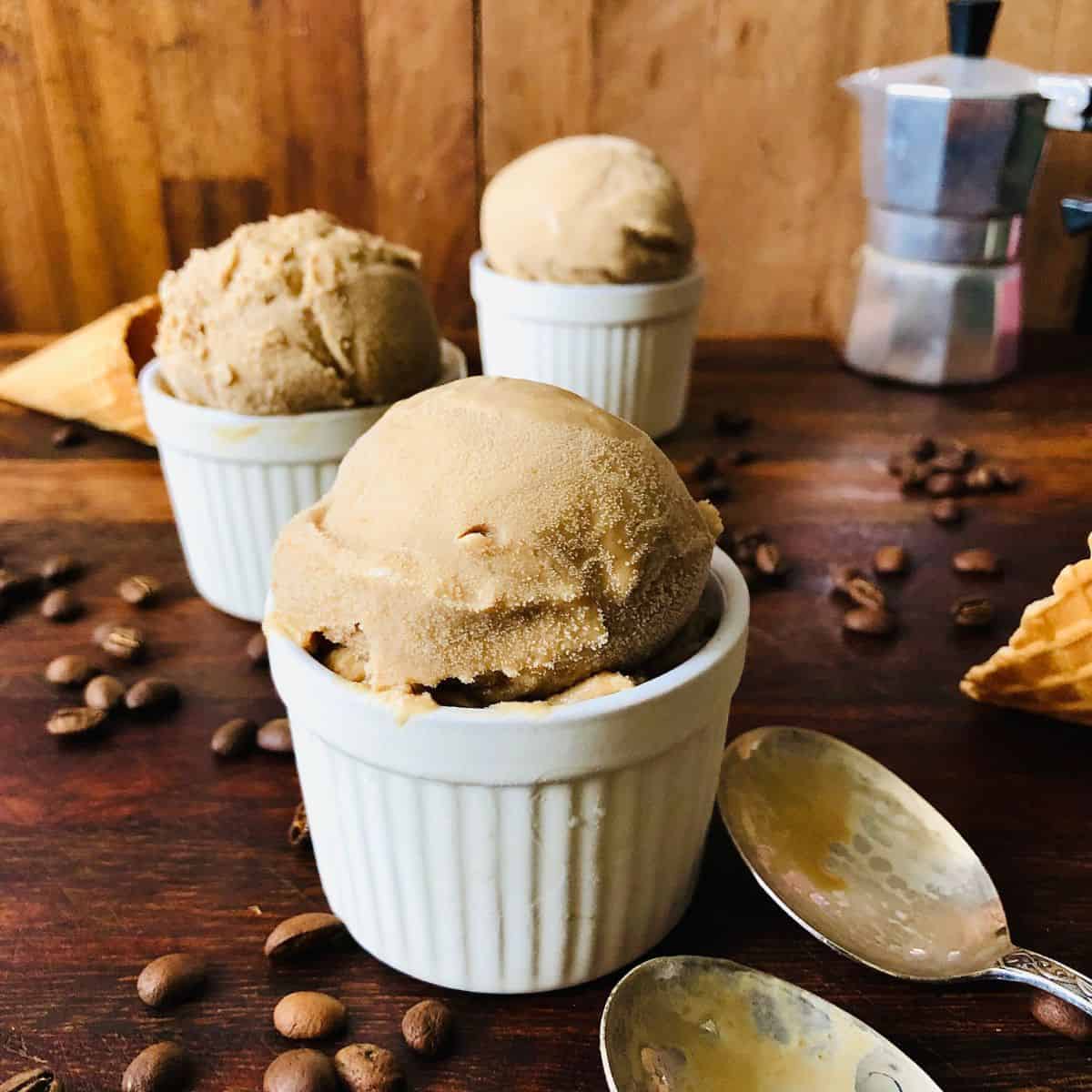 A scoop of coffee ice cream on a small dish.