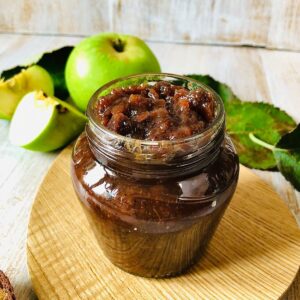 A small jar containing spiced apple chutney.