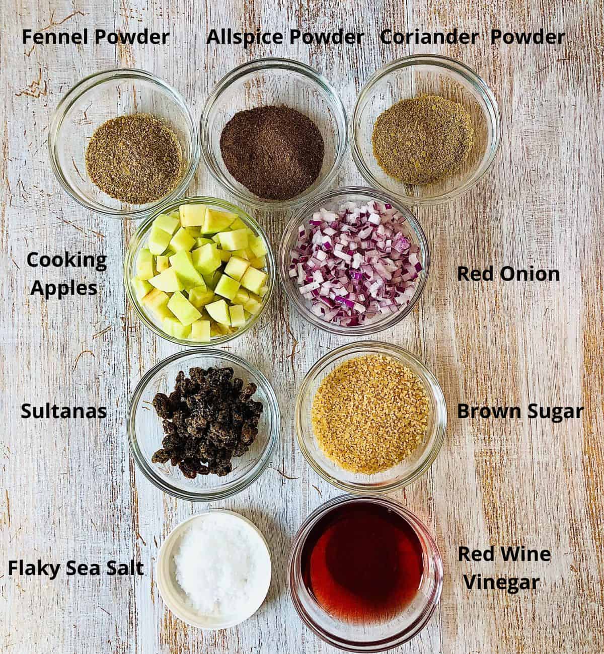 Prepared ingredients for spiced apple chutney with red onion in small glass dishes. Annotated.