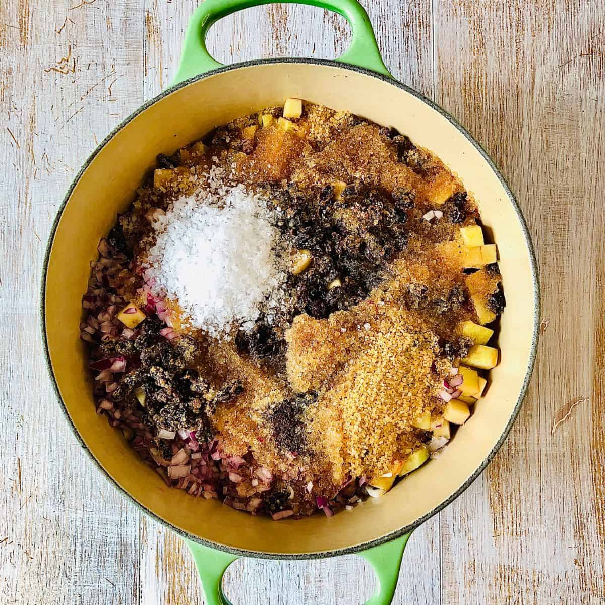 A large heavy duty pot containing all ingredients for spiced apple chutney, ready to cook.