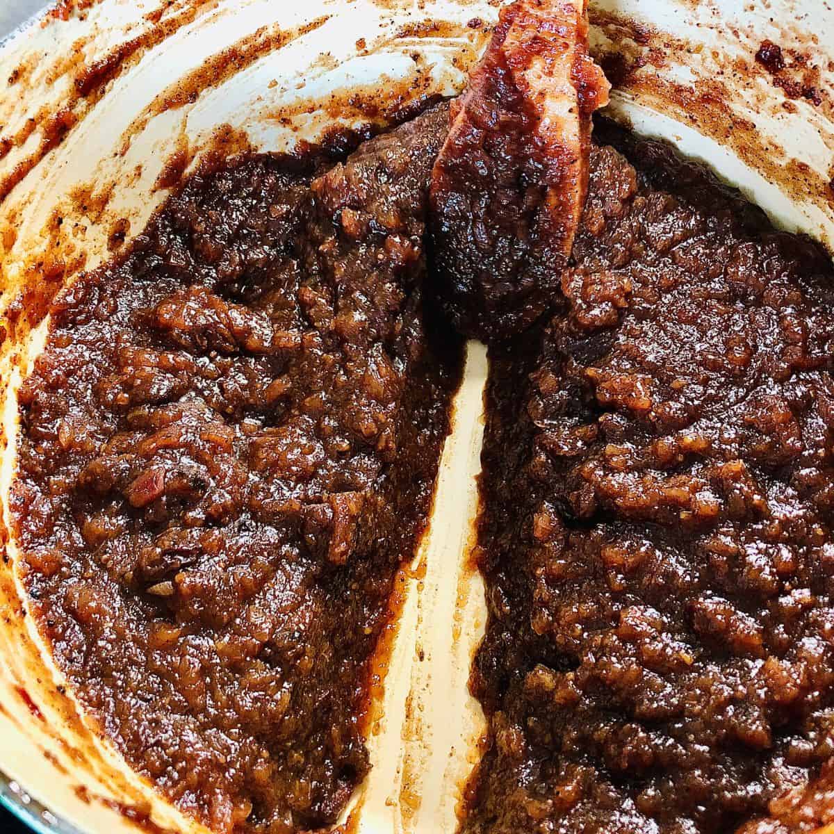 Close up of cooked spiced apple chutney in a large heavy duty pot.