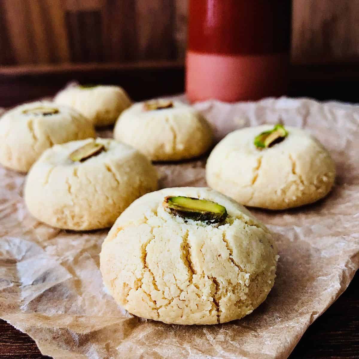 Close up of six nankhatai biscuits on parchment paper.