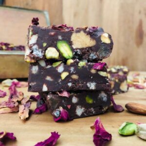 Close up of three slices of rocky road stacked on top of each other.