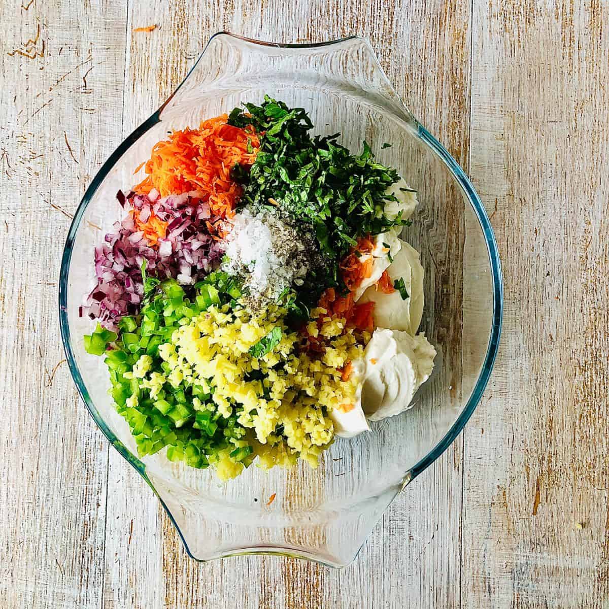 Prepared ingredients for dahi ke kabab in a glass bowl ready to mix together.